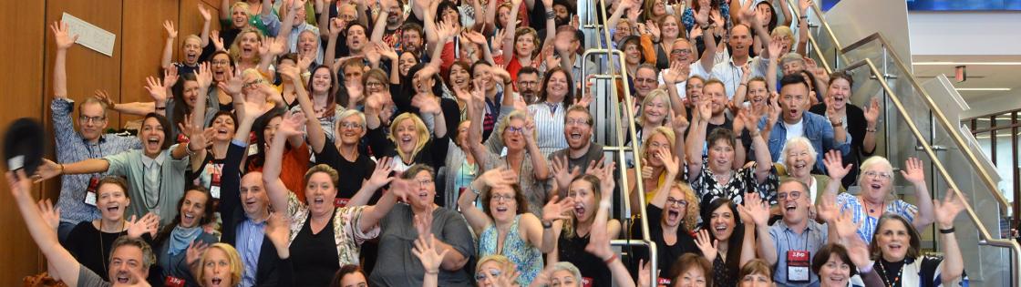 Attendees of the 2019 conference posing on a stairwell.